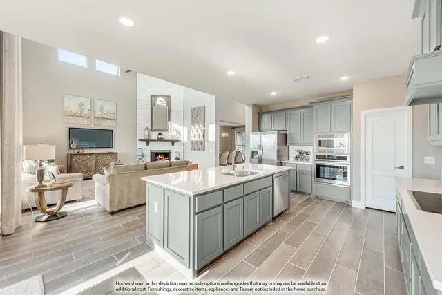 a kitchen with a sink stove cabinets and refrigerator