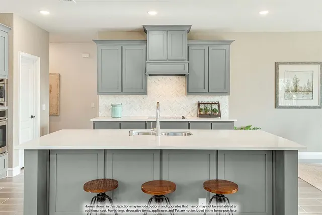 a kitchen with a sink a stove and cabinets