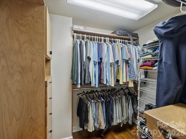 a view of walk in closet with clothes