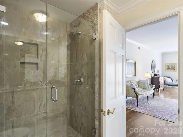 a bathroom with a glass shower door and a sink