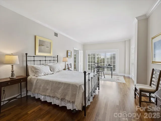 a bedroom with a bed a table and chair