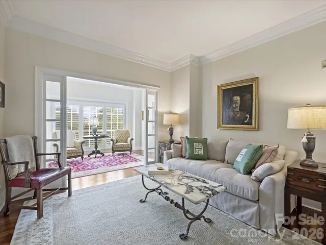 a living room with furniture and a floor to ceiling window
