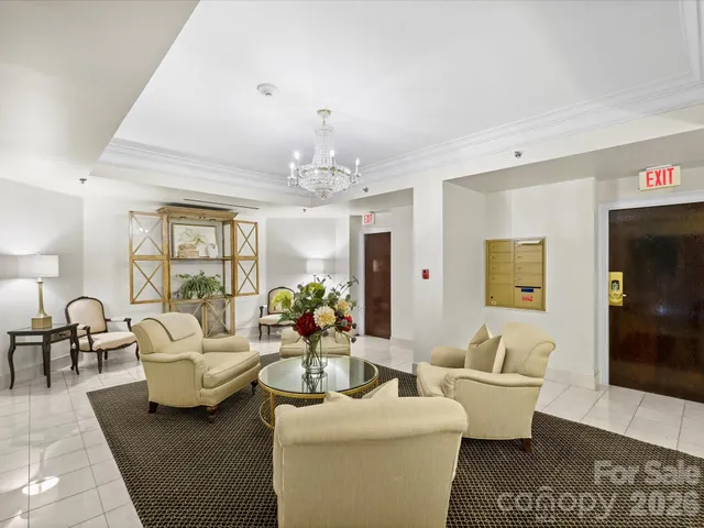 a living room with furniture and a chandelier
