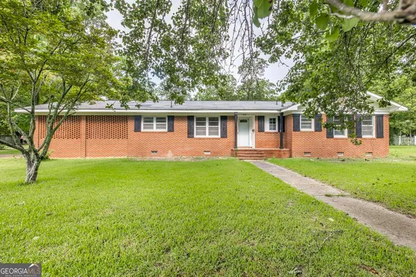 a front view of house with yard and green space