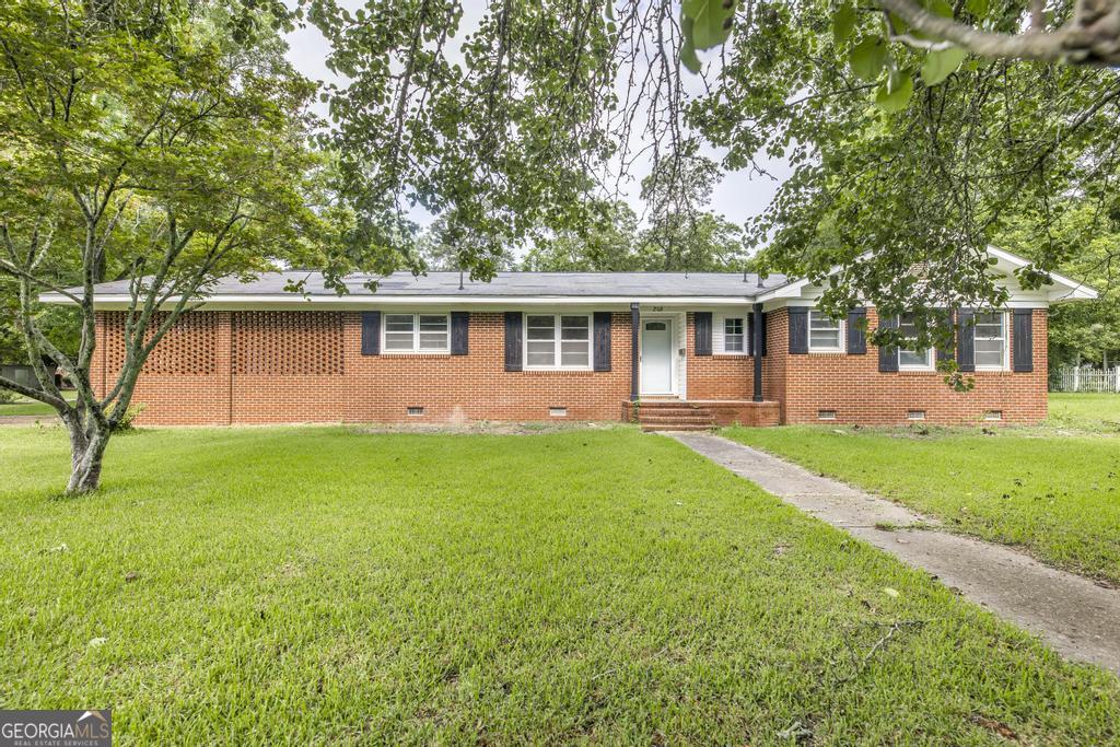 a front view of house with yard and green space