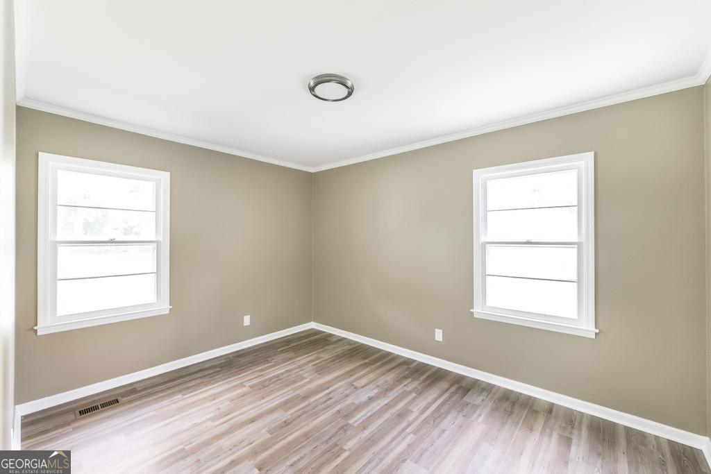 208 South 6th Street Vienna, GA 31092 - Photo 21 of 29 a view of a room with wooden floor and windows