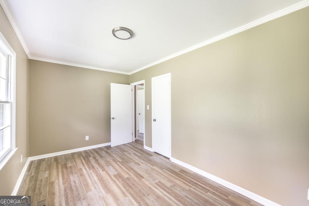 208 South 6th Street Vienna, GA 31092 - Photo 22 of 29 a view of empty room with wooden floor and fan