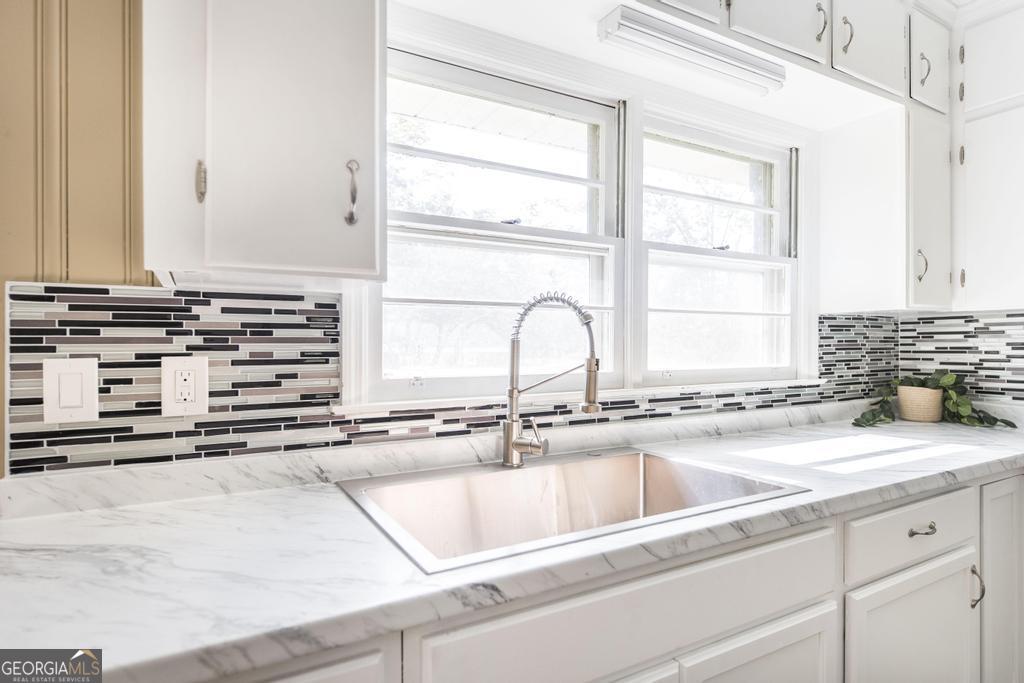 208 South 6th Street Vienna, GA 31092 - Photo 6 of 29 a kitchen with stainless steel appliances cabinets a sink and a window