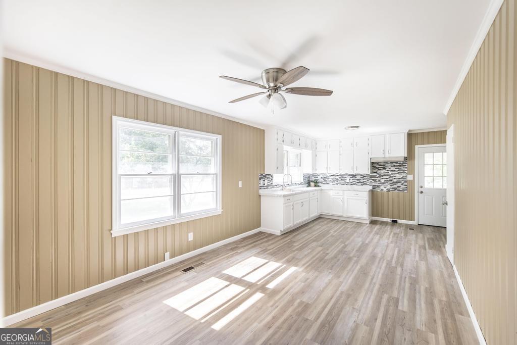 208 South 6th Street Vienna, GA 31092 - Photo 10 of 29 a view of a kitchen with wooden floor and a window