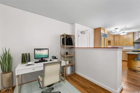 a view of a workspace with furniture and a window