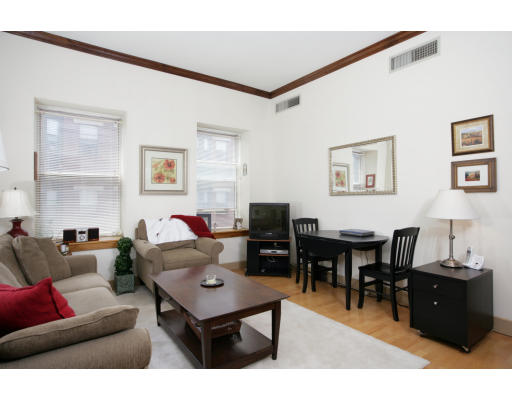 100 Fulton Street, Unit 3C Boston, MA 02109 - Photo 2 of 6 a living room with furniture a desk and chair with wooden floor