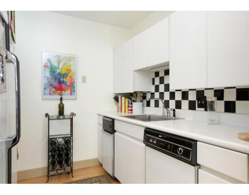 100 Fulton Street, Unit 3C Boston, MA 02109 - Photo 4 of 6 a kitchen with a sink a stove and cabinets