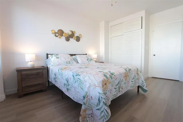 a bedroom with a bed and a painting on the wall