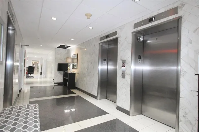 a view of a lobby with kitchen and windows