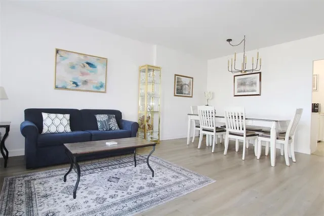 a living room with furniture a dining table and a dining table with wooden floor