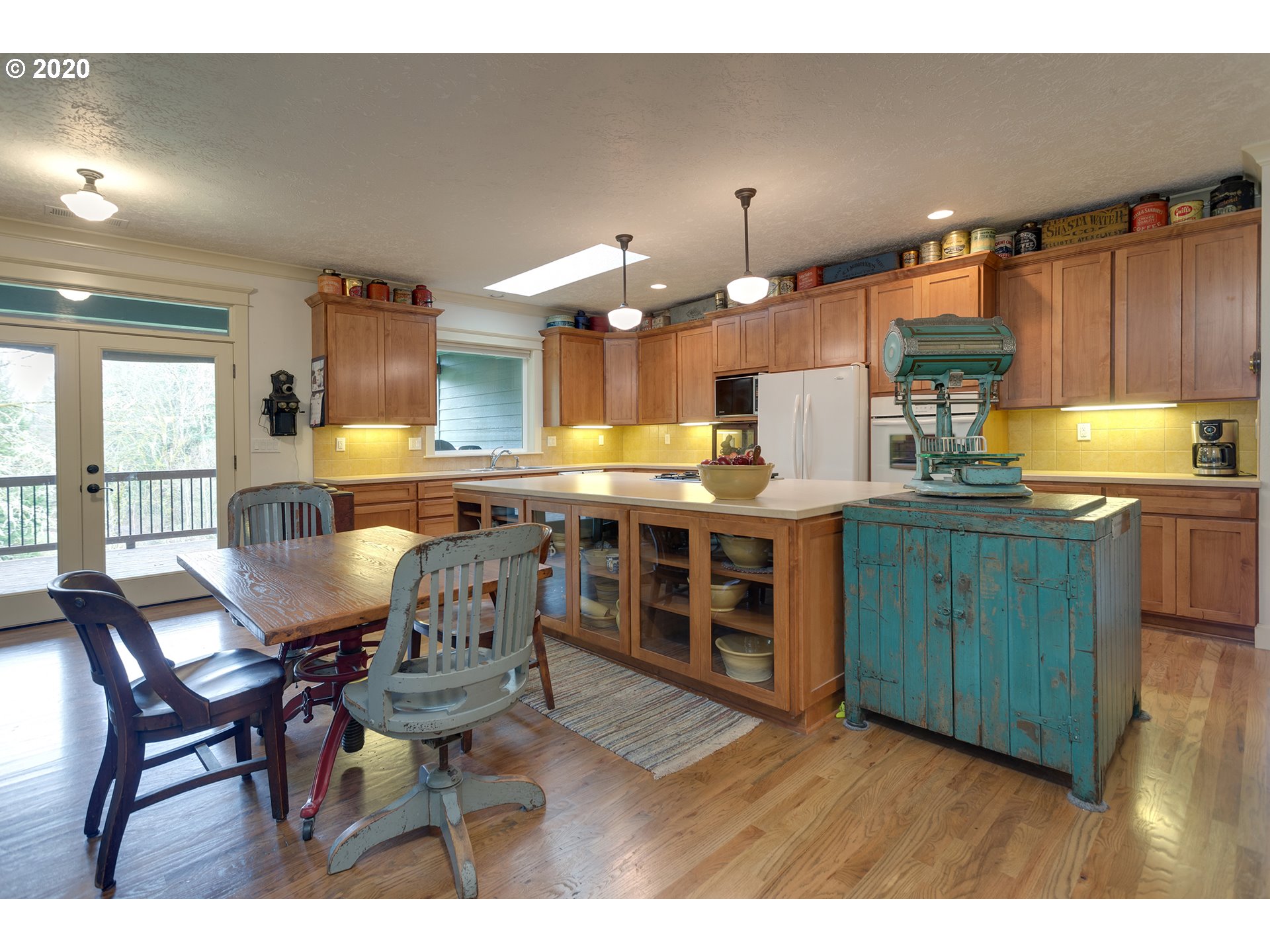 37220 Southeast Bluff Road Boring, OR 97009 - Photo 7 of 26 a kitchen with stainless steel appliances kitchen island granite countertop a table chairs and a living room