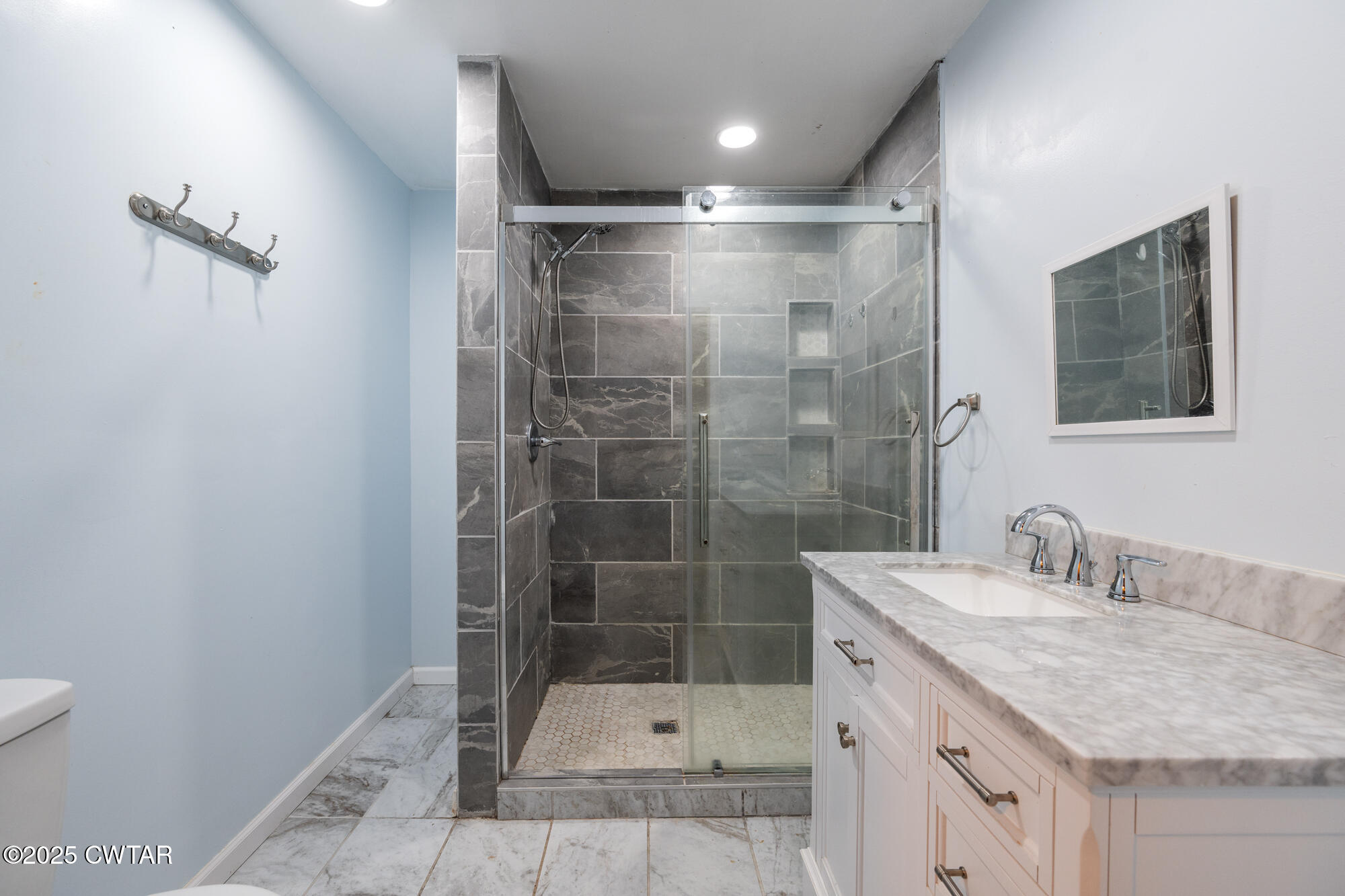 110 Highway 220 Cedar Grove, TN 38321 - Photo 3 of 12 a bathroom with a shower sink and mirror