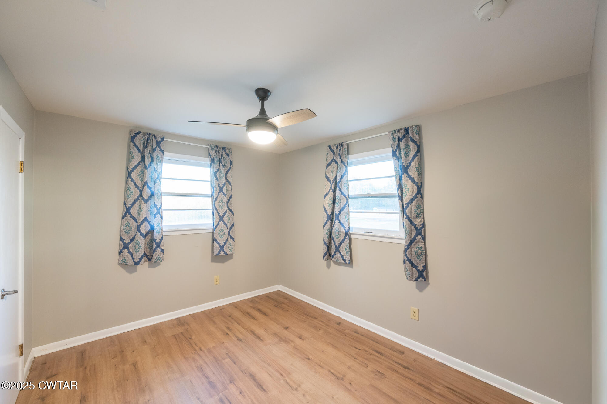 110 Highway 220 Cedar Grove, TN 38321 - Photo 4 of 12 an empty room with windows and fan