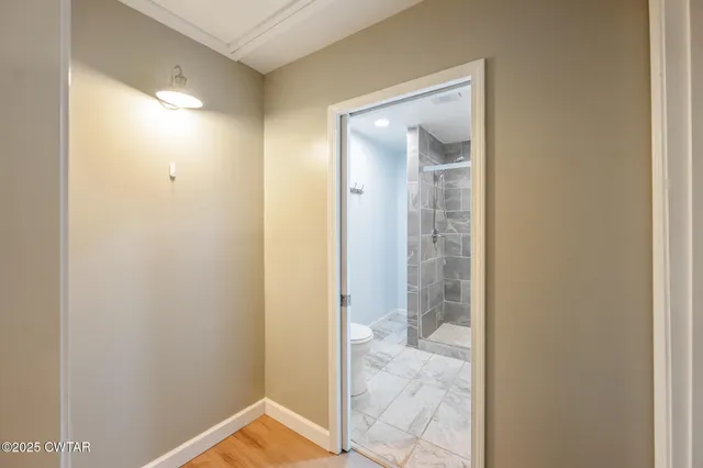 a view of a bathroom from a hallway