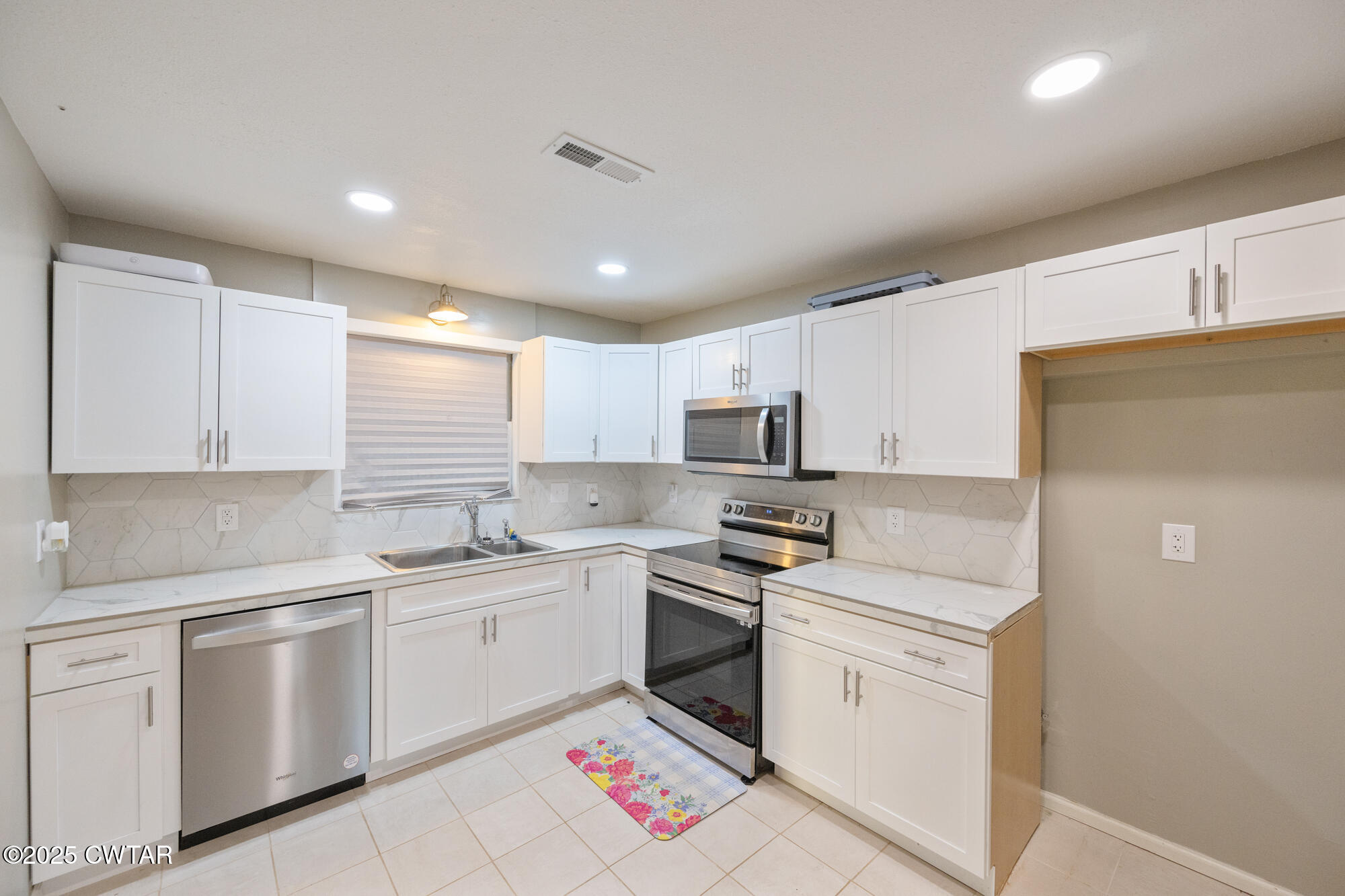 110 Highway 220 Cedar Grove, TN 38321 - Photo 9 of 12 a kitchen with white cabinets sink and white appliances