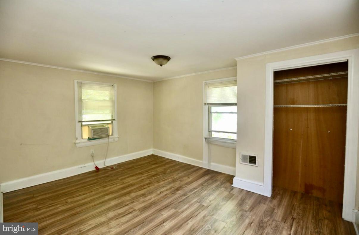 310 Ellis Street Glassboro, NJ 08028 - Photo 9 of 15 an empty room with wooden floor and windows