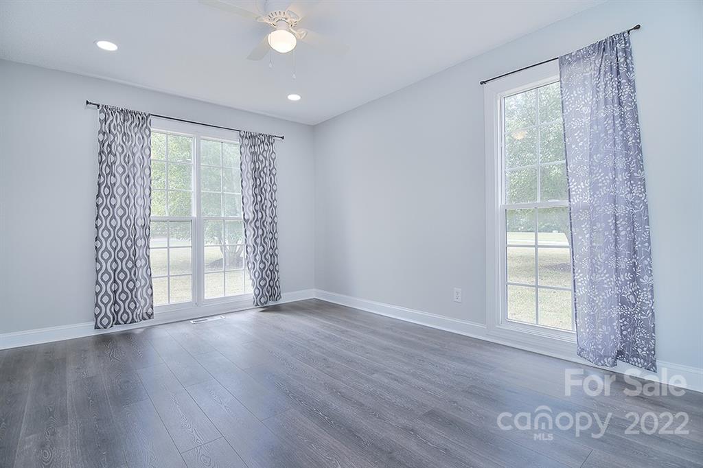 3411 Helms Pond Road, Unit 3 Monroe, NC 28110 - Photo 23 of 33 a view of an empty room with wooden floor and a window