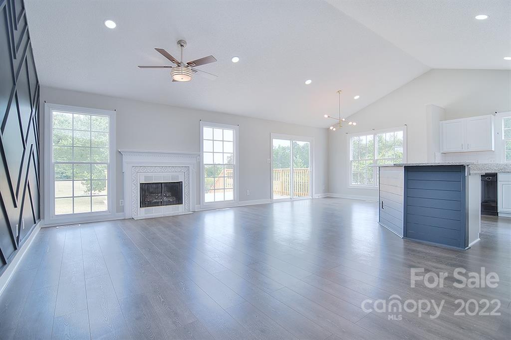 3411 Helms Pond Road, Unit 3 Monroe, NC 28110 - Photo 5 of 33 an empty room with wooden floor fireplace and windows
