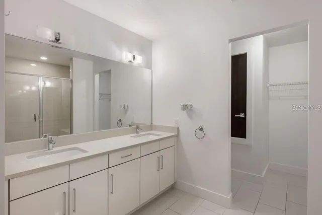 a bathroom with a double vanity sink and mirror