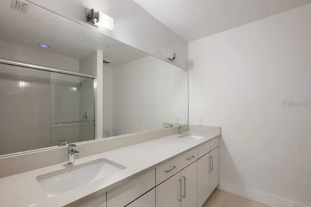a bathroom with a sink vanity and a mirror