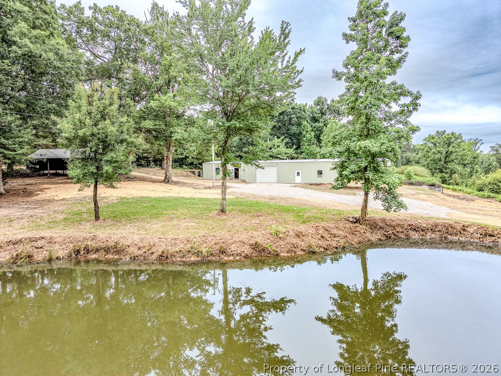 2957 Cypress Church Road Cameron, NC 28326 - Photo 5 of 48 Pond view to shop and tractor shed