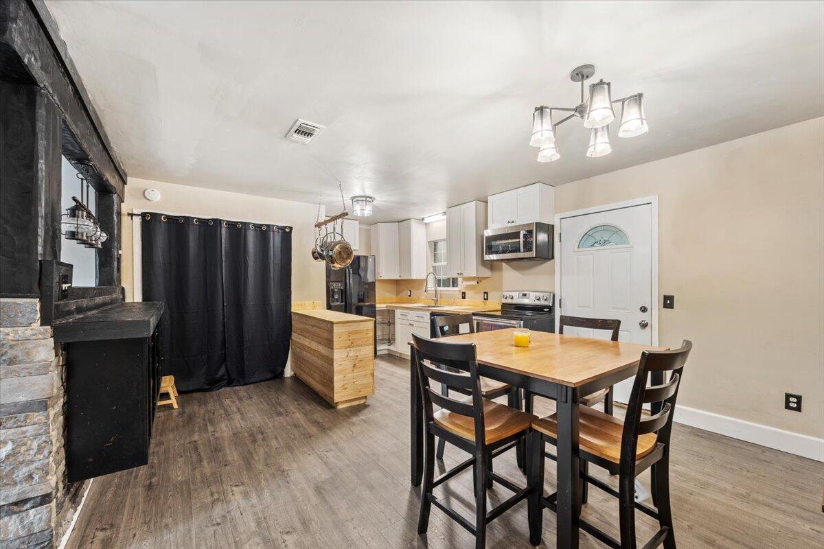 6060 Allegro Street Milton, FL 32583 - Photo 11 of 32 a view of a dining room with furniture and wooden floor