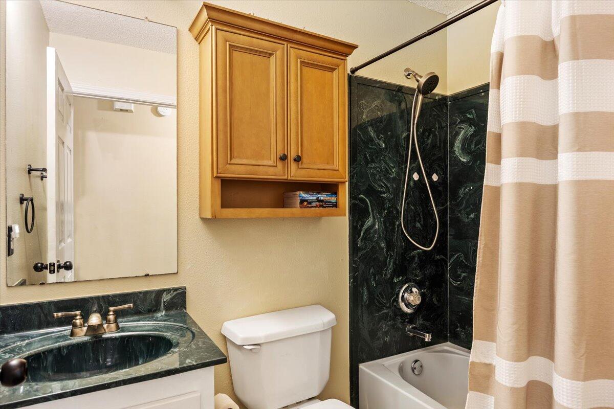 6060 Allegro Street Milton, FL 32583 - Photo 13 of 32 a bathroom with a sink a toilet and shower