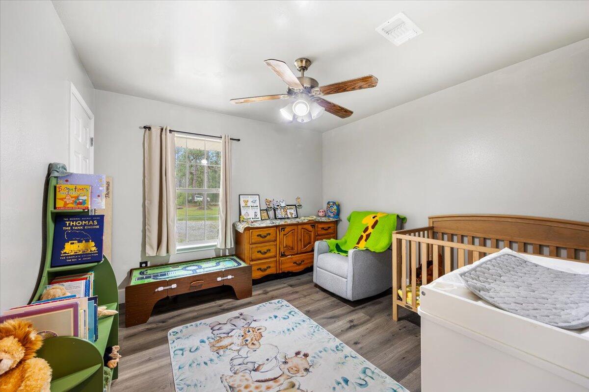 6060 Allegro Street Milton, FL 32583 - Photo 14 of 32 a bedroom with bed and window