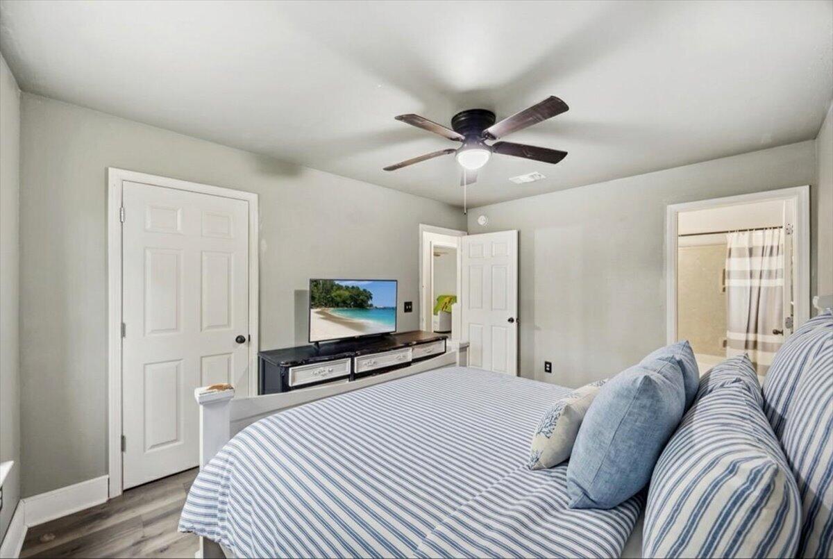 6060 Allegro Street Milton, FL 32583 - Photo 18 of 32 a bedroom with a bed and a flat screen tv