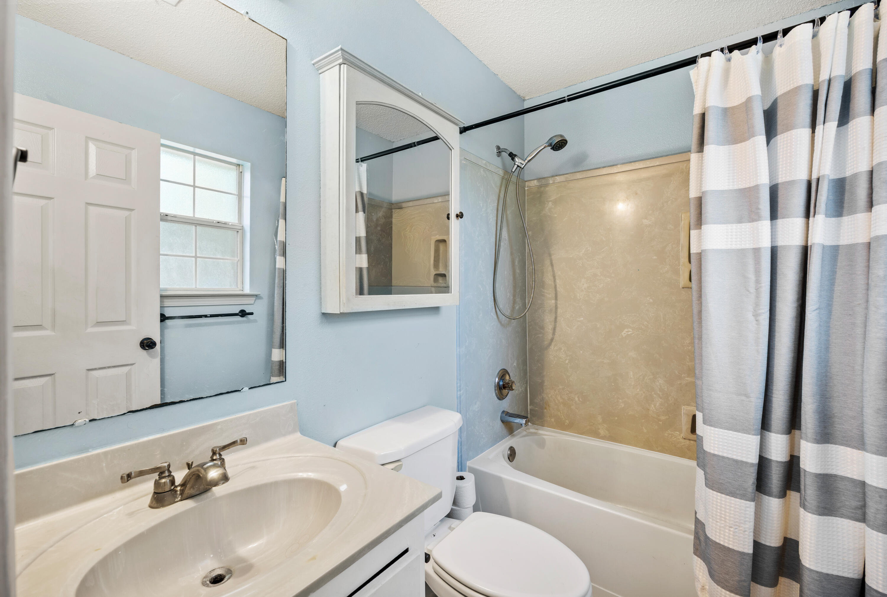 6060 Allegro Street Milton, FL 32583 - Photo 19 of 32 a bathroom with a sink toilet and shower