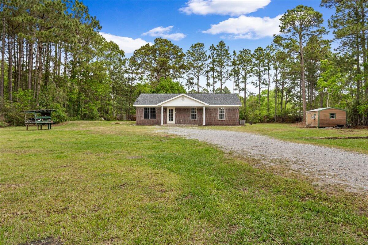 6060 Allegro Street Milton, FL 32583 - Photo 2 of 32 a front view of a house with garden