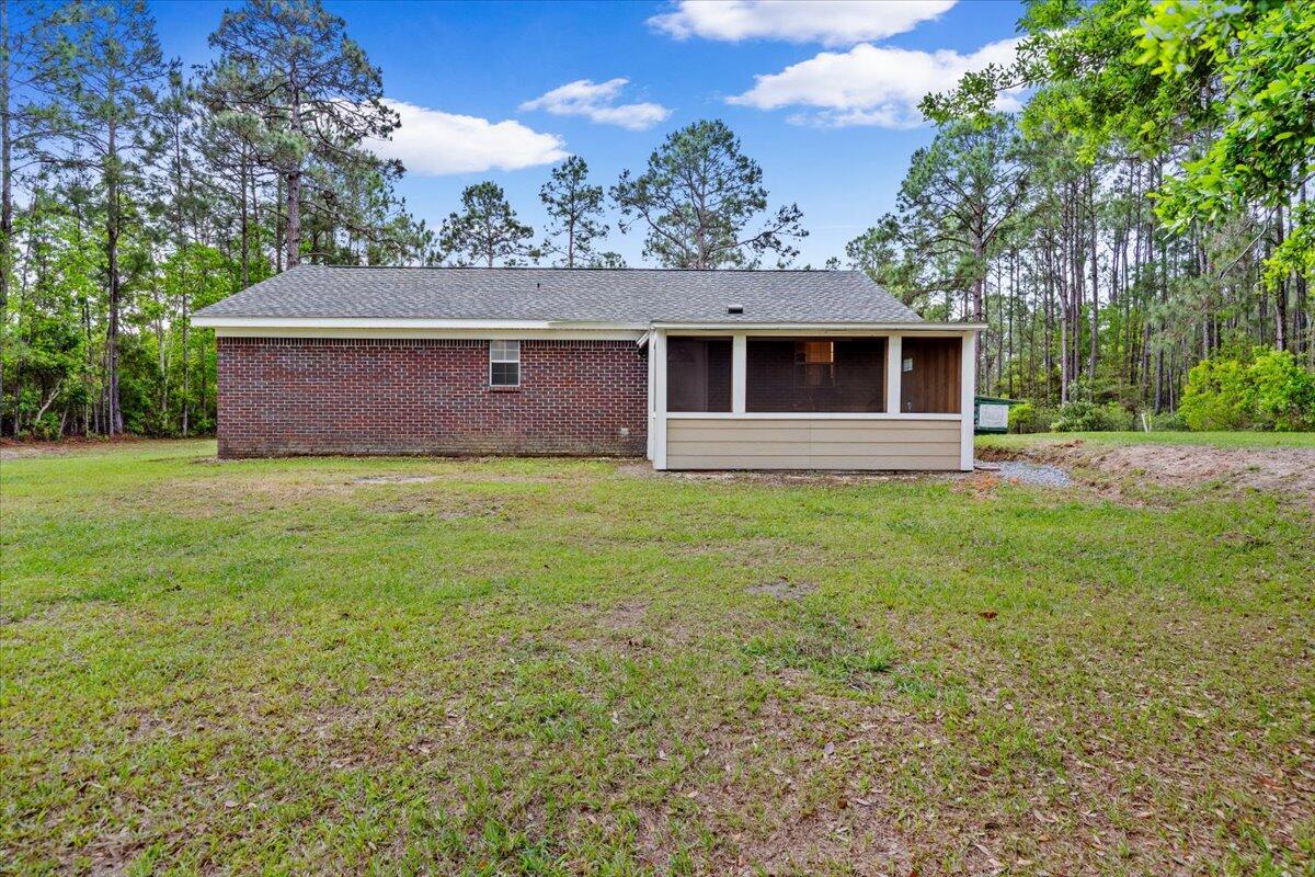 6060 Allegro Street Milton, FL 32583 - Photo 23 of 32 a front view of a house with a yard