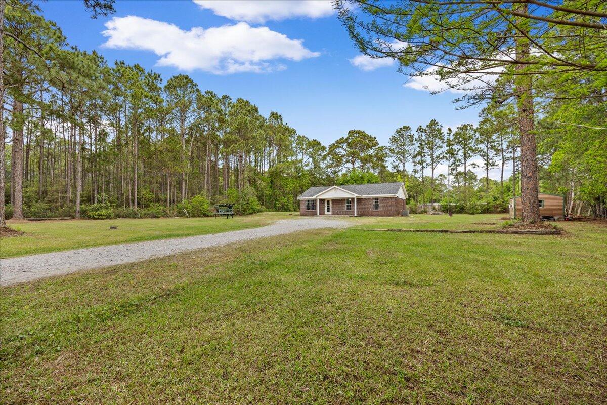 6060 Allegro Street Milton, FL 32583 - Photo 25 of 32 a view of a house with a big yard