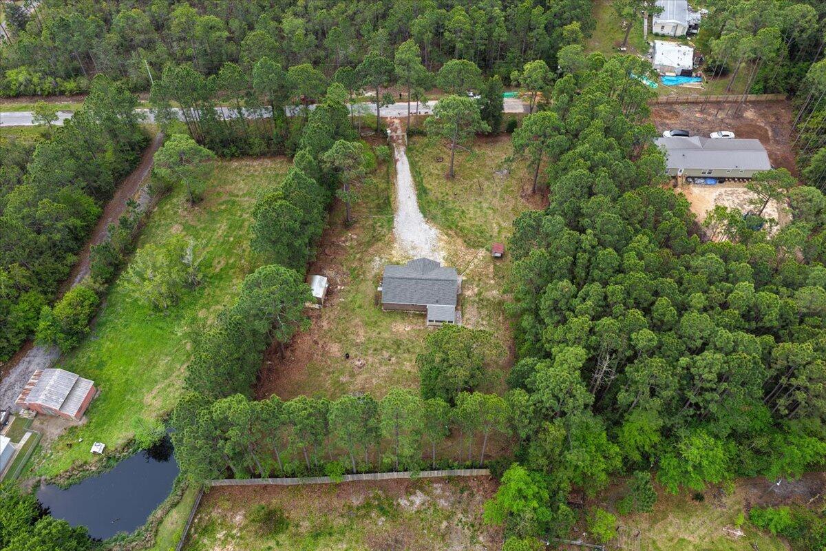 6060 Allegro Street Milton, FL 32583 - Photo 29 of 32 an aerial view of residential houses with outdoor space and trees