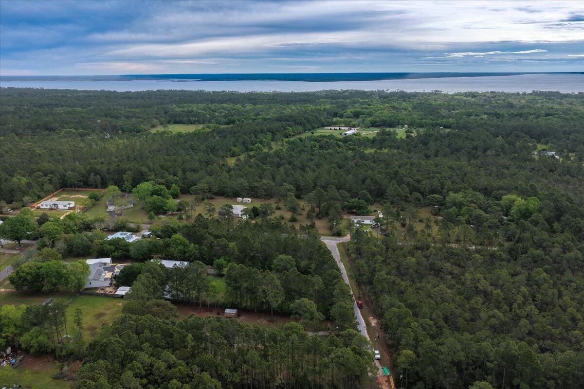 6060 Allegro Street Milton, FL 32583 - Photo 31 of 32 a view of a city with lush green forest