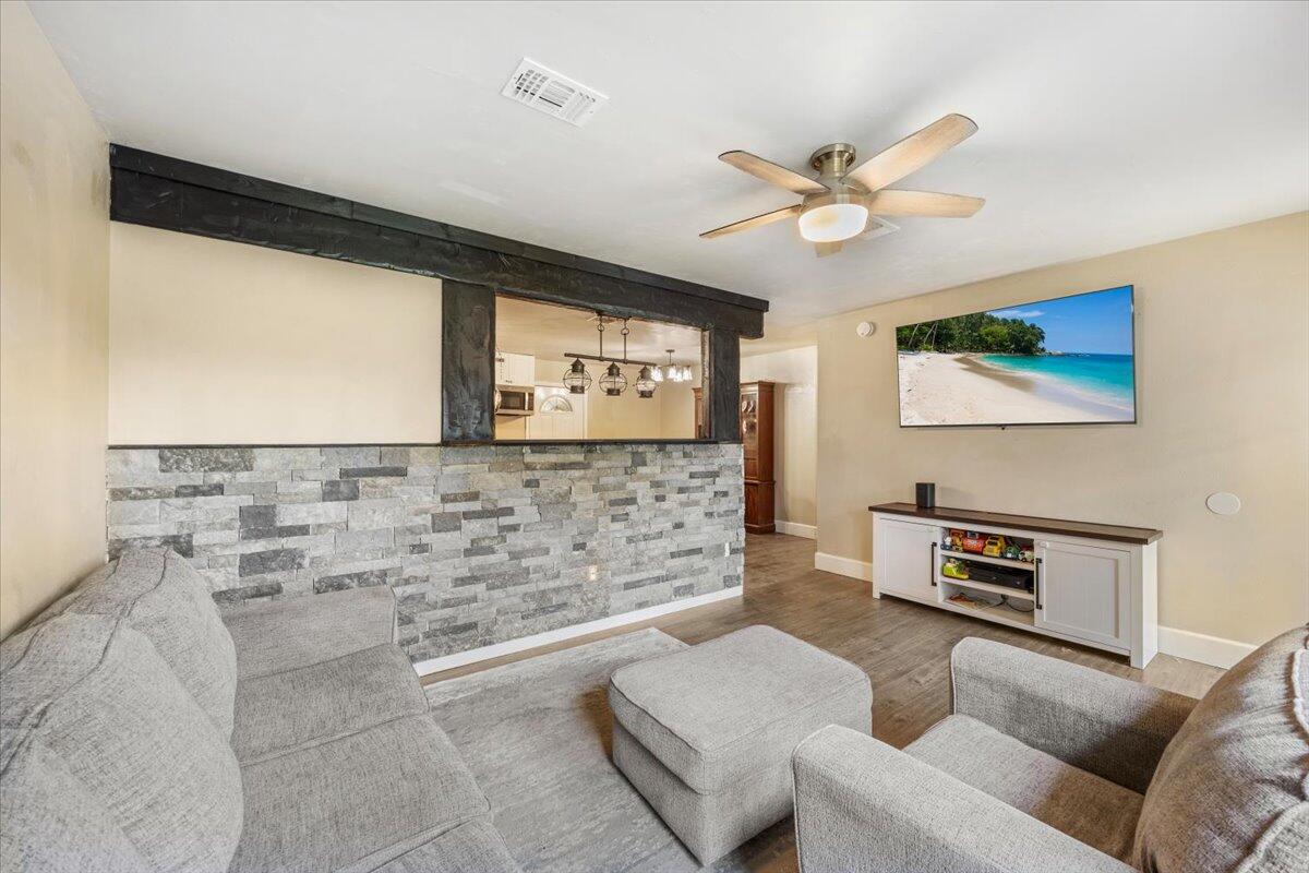 6060 Allegro Street Milton, FL 32583 - Photo 4 of 32 a living room with furniture and a flat screen tv