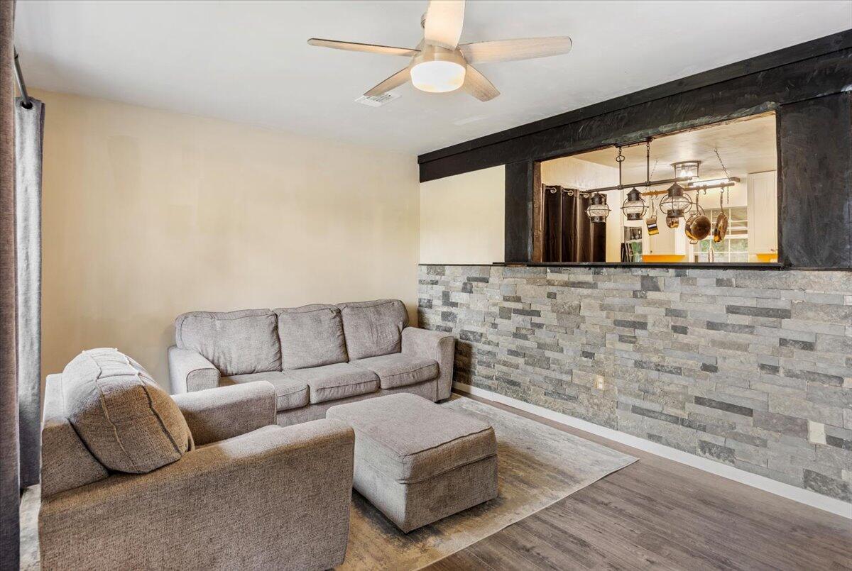 6060 Allegro Street Milton, FL 32583 - Photo 5 of 32 a living room with furniture and a flat screen tv