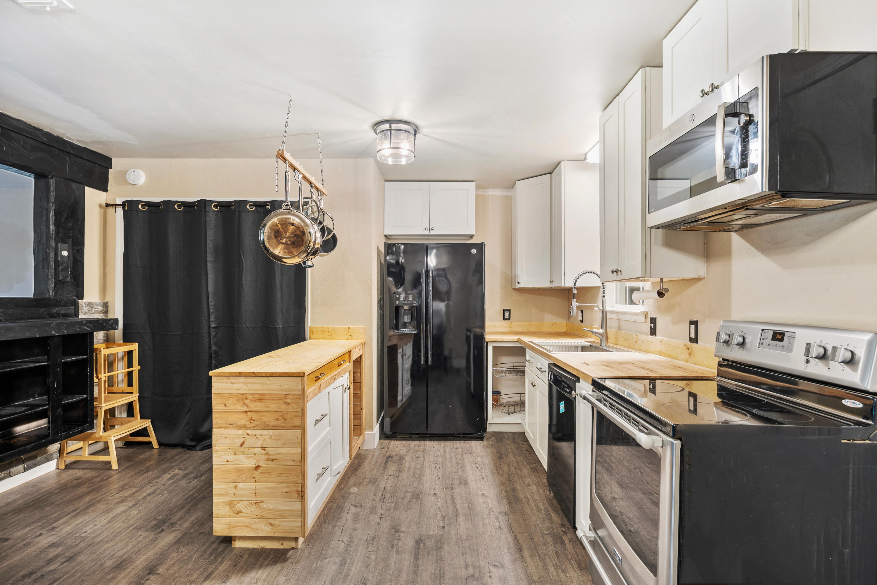 6060 Allegro Street Milton, FL 32583 - Photo 6 of 32 a kitchen with a refrigerator and a stove top oven