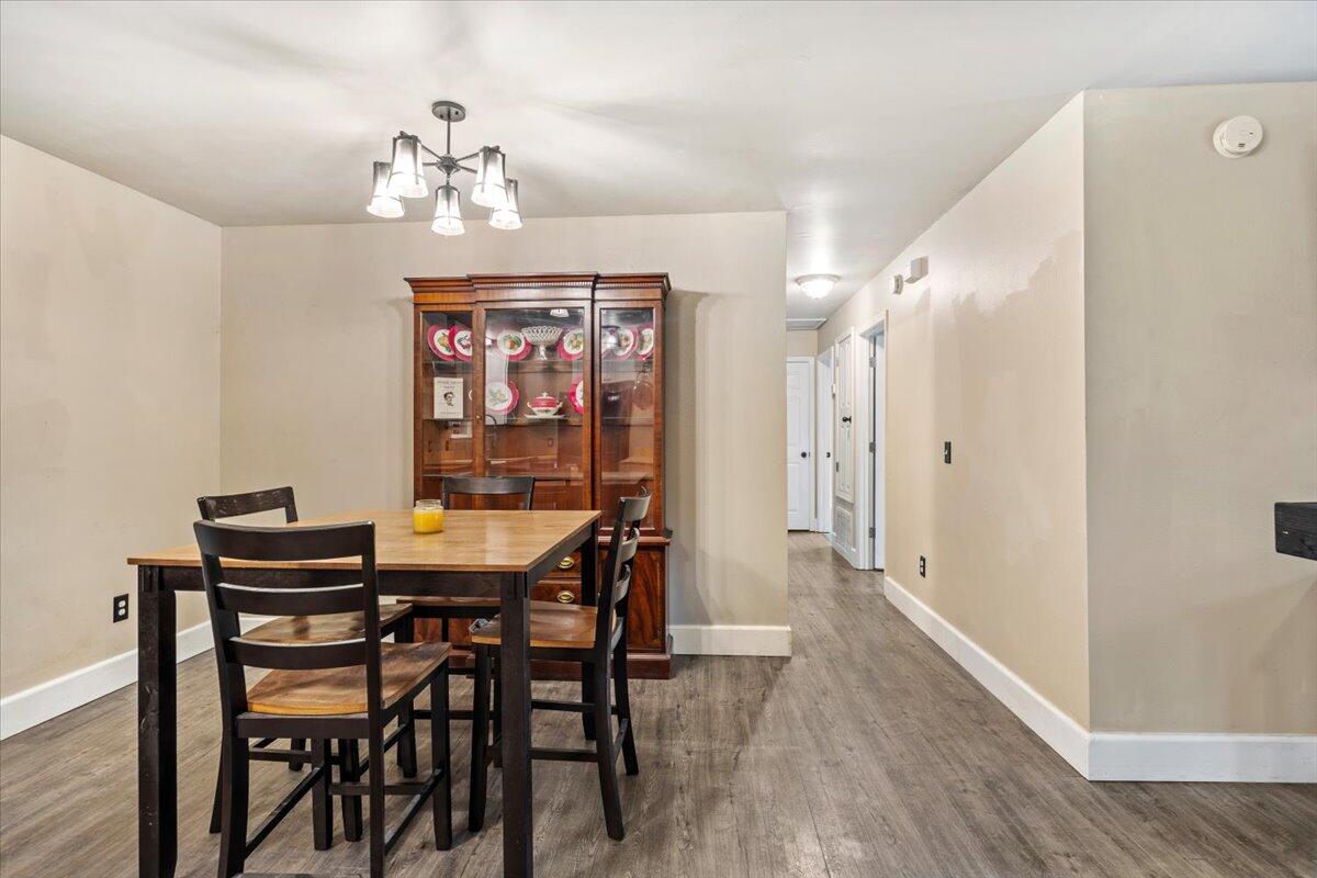 6060 Allegro Street Milton, FL 32583 - Photo 8 of 32 a view of a dining room with furniture wooden floor and chandelier