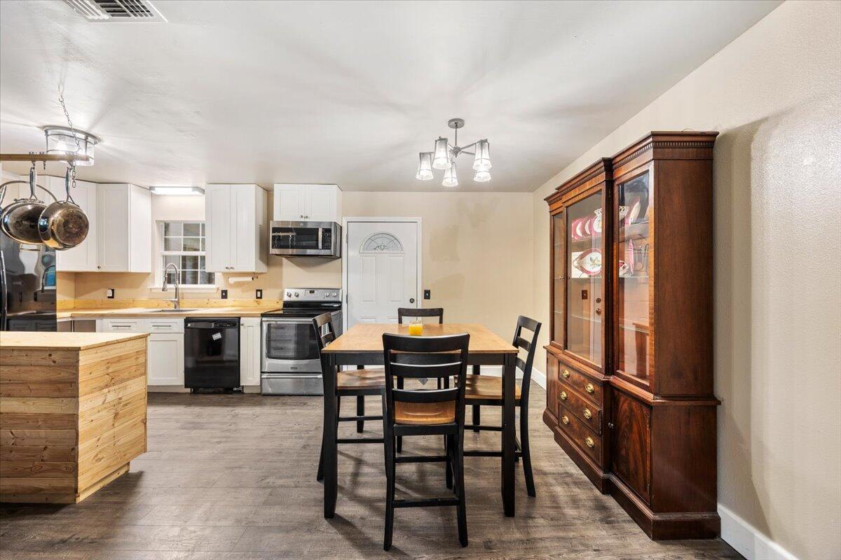 6060 Allegro Street Milton, FL 32583 - Photo 10 of 32 a view of a dining room with furniture window and wooden floor
