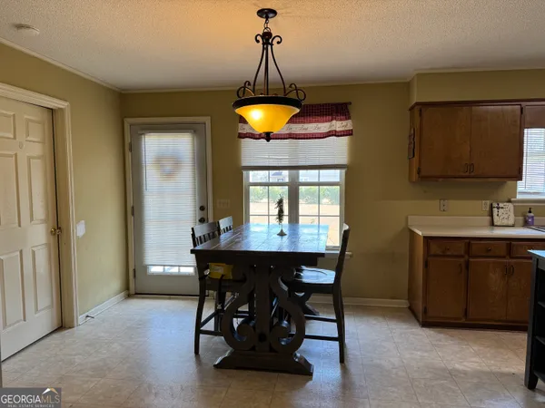 a dining room with furniture and window