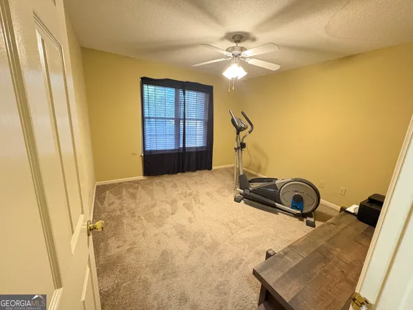 a room with a bed and a chandelier