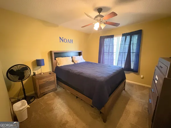a bedroom with a bed and dresser