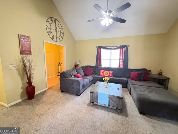 a living room with furniture and a window