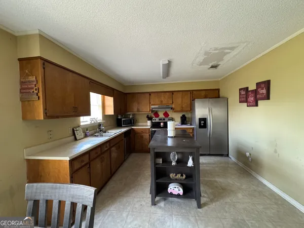 a large kitchen with a lot of counter space and a sink